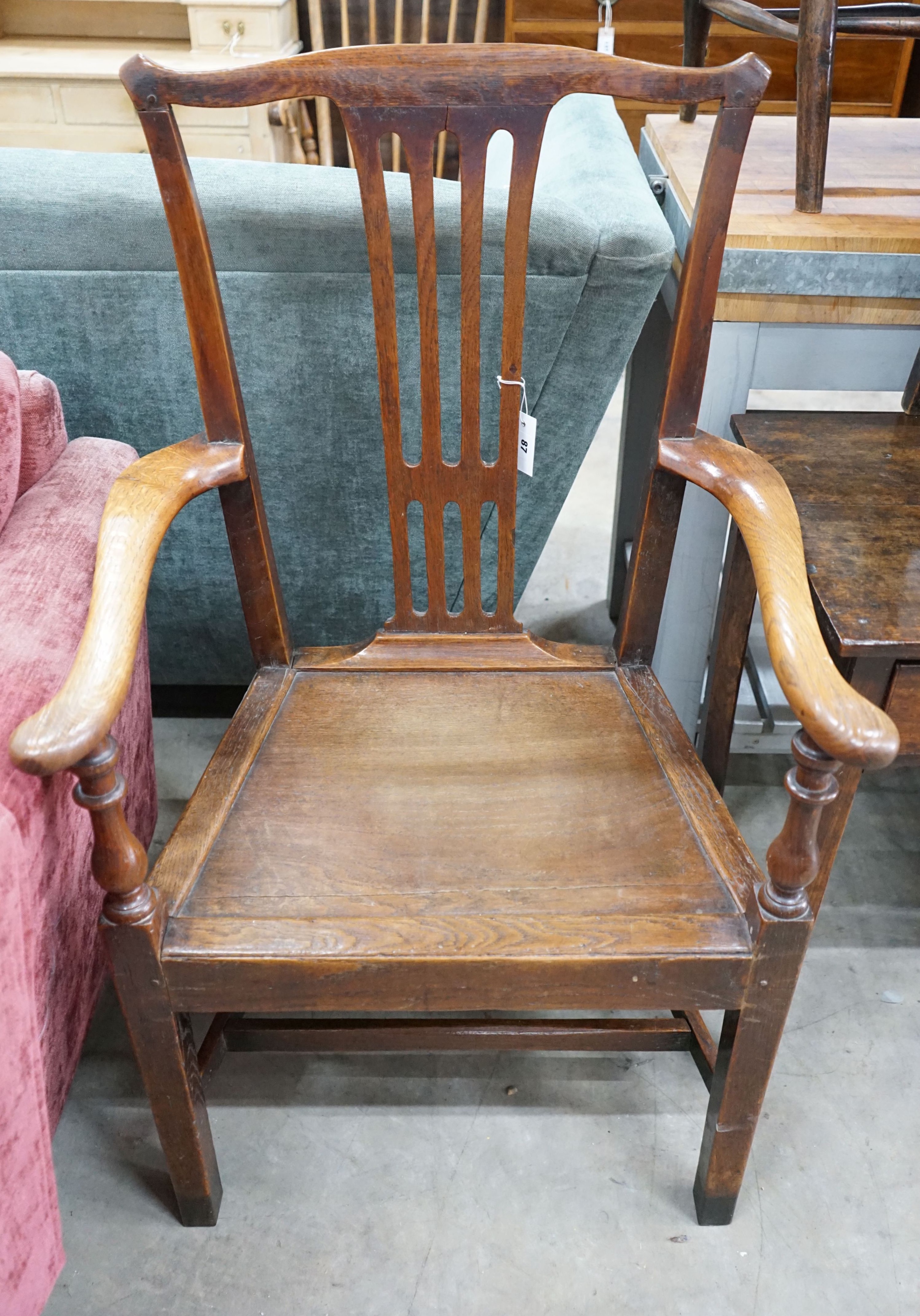 A large George III oak wood seat elbow chair, width 68cm, depth 47cm, height 112cm